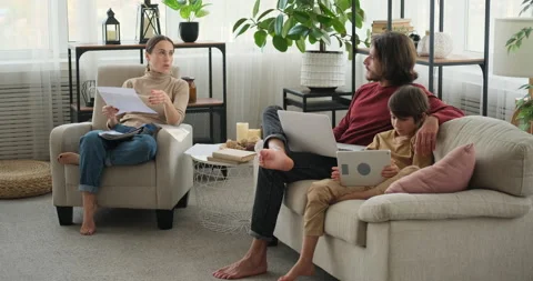 Parents analyzing documents and son using digital tablet Stock Footage 145227382