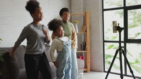 Parents and children make dancing video for social media at home Stock Footage 164284748