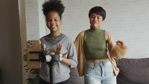 Parents and children make dancing video for social media at home Video stock 164292573