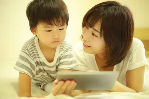 Parents and children using tablet devices Stock Photos