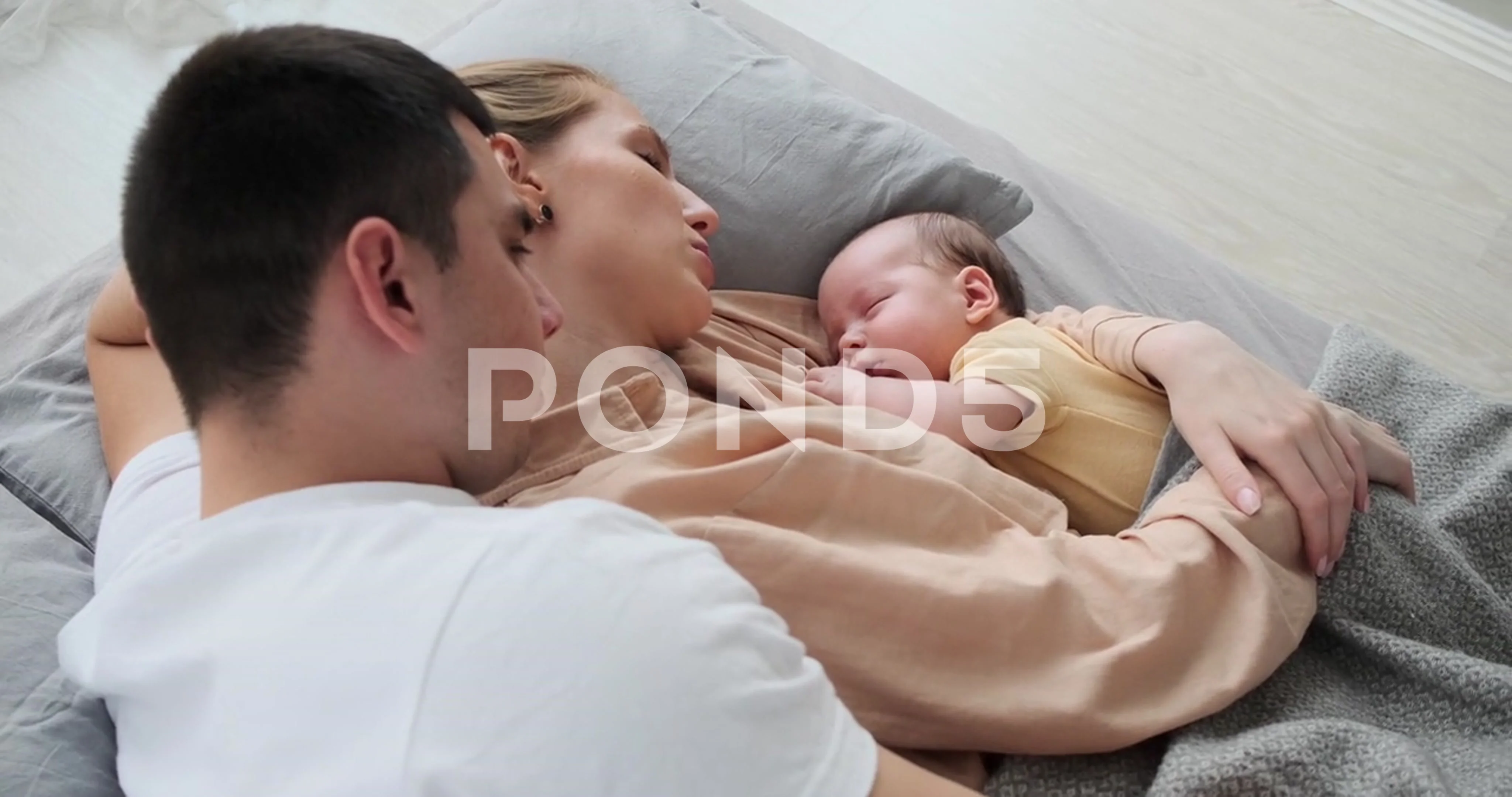 babies sleeping in parents arms