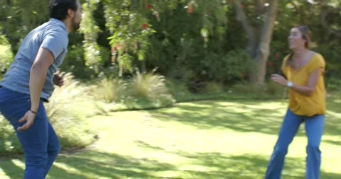 Parents chasing child after child dashing past man, woman in yellow top running Stock Footage 338326645