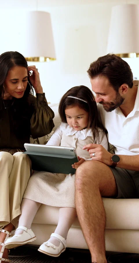 Parents, child and tablet with game on sofa for problem solving, development or Stock Footage 337689841