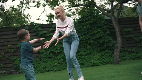 Parents with a child have fun in the backyard Stock Footage 160950480