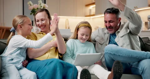 Parents, children and high five in home with tablet, learning game and Stock Footage 337924178