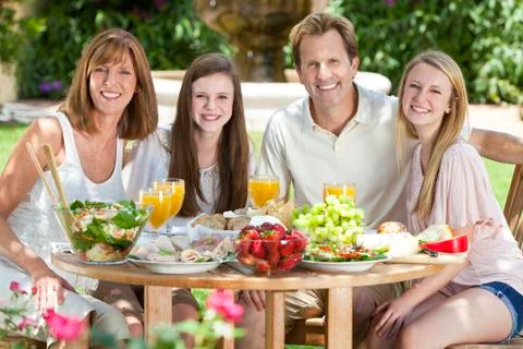Parents children family healthy eating outside Stock Photos