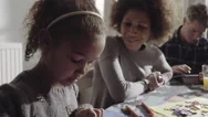 Parents With Daughter Drawing In Living Room Stock Footage