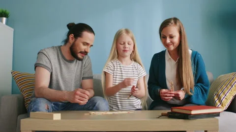 Parents Devote Time to Their Daughter Playing Together Stock Footage 135378302