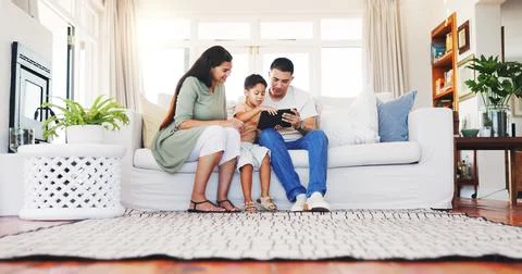 Parents, elearning and child with tablet in lounge, development or watching Stock Photos