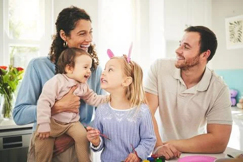 Parents, girl children and bunny ears in family home with funny face, baby or Stock Photos