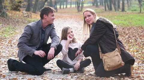 Parents having fun with daughter in the park, waving at camera Stock Footage 59553811