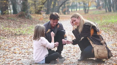 Parents having fun with daughter playing games in the park Stock Footage 59553783