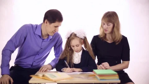 Parents help daughter to do homework Stock Footage 72917073