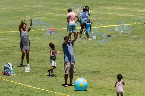 Parents Make Large Bubbles With Soapy Water At Atlanta Festival Stock Photos
