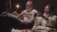 Parents Passing Food At The Dinner Table To Their Adult Children Stock Footage