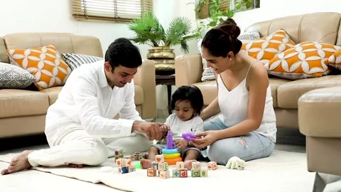 Parents play with their young son in the living room. Stock Footage 229255152