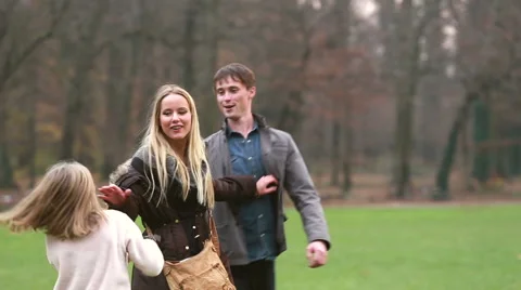 Parents playing with daughter in park Stock Footage 59554522