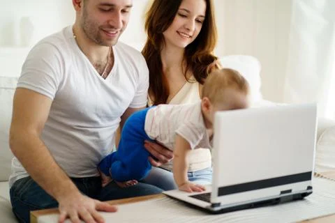 Parents playing developing game with son Stock Photos