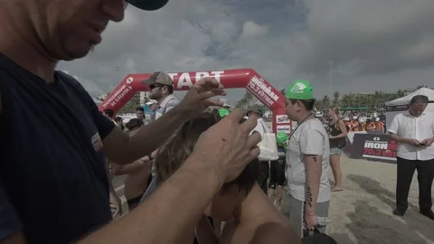 Parents preparing for kid before swim start at IRONKIDS in Danang, Vietnam in Stock Footage 155929633