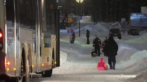 Parents pulling the plastic sleds with their cheery kids on Levi ski resort in Stock Footage 123088432
