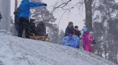 Parents Pushes a Sleighs Bucha Ukraine Children Riding on a Sleigh Downhill 動画素材 59132199