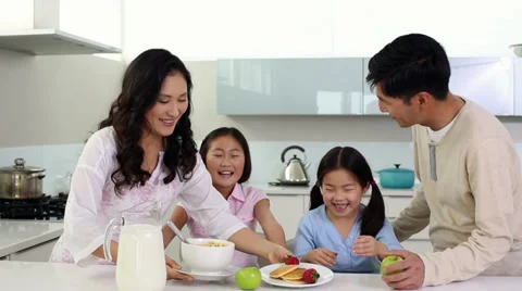 Parents serving breakfast to their cute daughters Stock Footage 32880899