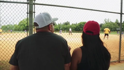 Parents sitting at baseball game Stock Footage 79734446