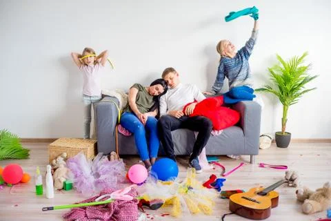 Parents sleeping in a middle of a mess Stock Photos