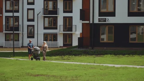 Parents with a stroller in an elite residential complex Stock Footage 313786034