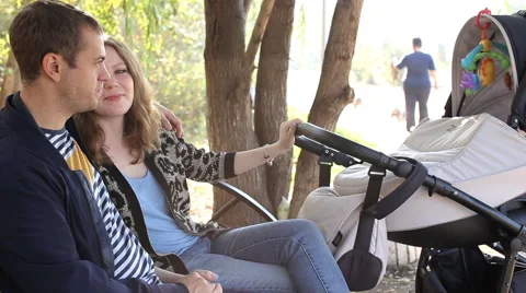Parents with stroller in park 스톡 동영상 55874967