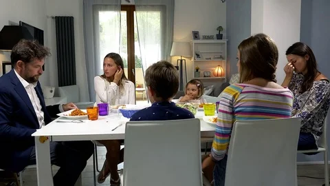 Parents at the table with family giving bad news sad Stock Footage