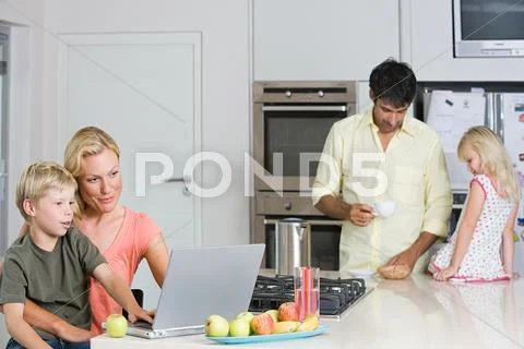Parents With Their Children In The Kitchen