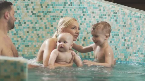 Parents with two sons having time together in SPA. Stock Footage 77806428