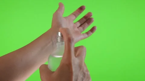 Parfume bottle  spray applying on the hand in front of green screen 4K  Stock Footage 52138148