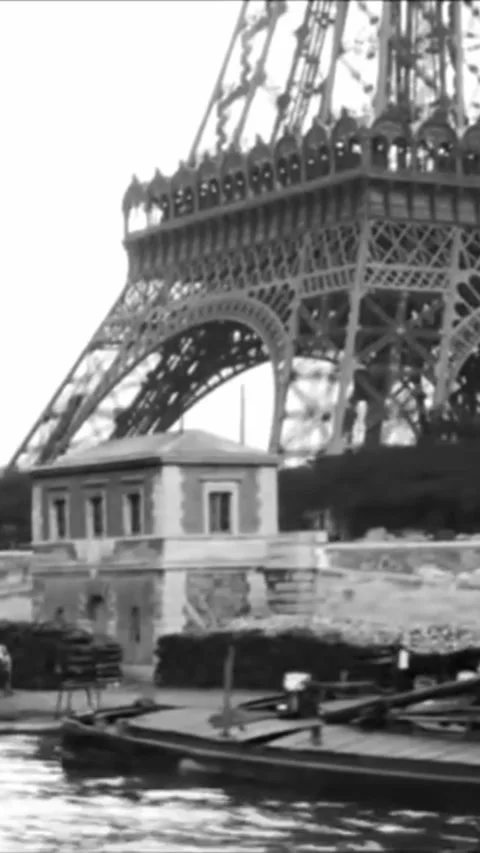 PARIS - 1880s - The Eiffel Tower is filmed from a boat sailing down the Seine in 스톡 동영상 342242162
