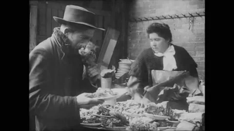 PARIS - 1910 - Poor men share meat and wine in a marketplace. Video stock 264756600