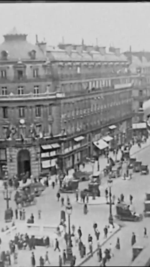 PARIS - 1927 - An aerial view from a balcony shows foot and vehicular traffic in Stock Footage 342244341