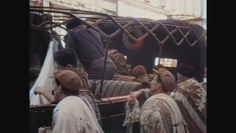 PARIS - 1933 - Men try to sell rugs to soldiers in a car in Paris, while others Stock Footage 259550680