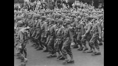 PARIS - 1944: 28th Division parade - Infantry ranks march beneath a Paris crowd 스톡 동영상 344005810