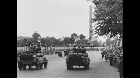 PARIS - 1944: Armored column - Armoured cars pass an obelisk flanked by flags Stock-Footage 344005842