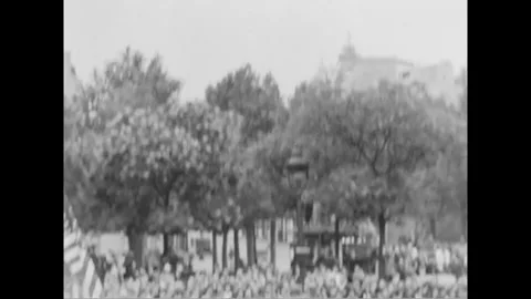 PARIS - 1944: Parade crowd - Crowd gathers under trees on a Paris pavement 库存影片 344005812