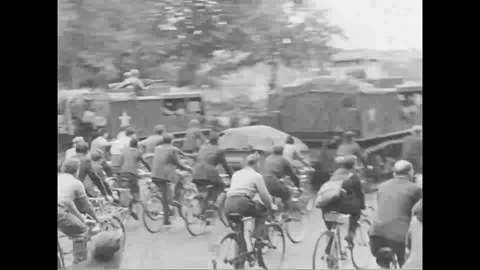 PARIS - 1944: Parade crowd - Crowd on bicycles surges past a military column Stock-Footage 344005852