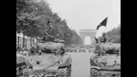 PARIS - 1944: Tank column - Two tanks advance with flags flying nearby 스톡 동영상 344005817