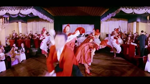 PARIS - 1955 - An acrobatic dancer performs in Paris' Lido Club with showgirls. Stock Footage 337882602
