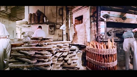 PARIS - 1955 - Bread is made and purchased at a Parisian bakery. Stock Footage 331946787