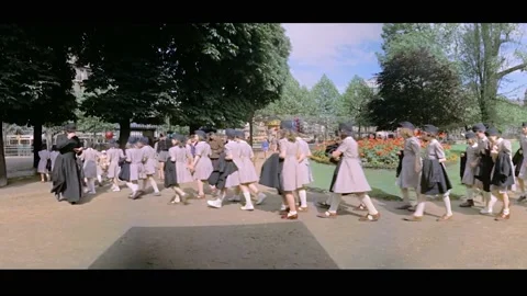 PARIS - 1955 - Children arrive for a performance of "Little Red Riding Hood" at Vídeos de archivo 331944867