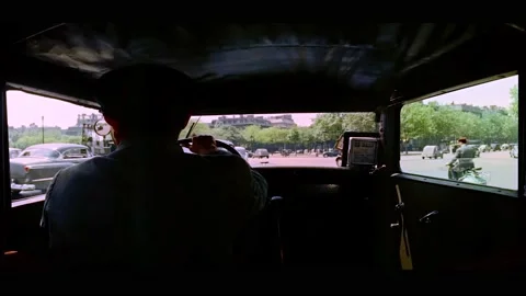 PARIS - 1955 - View from inside a cab as it enters a busy intersection in Paris. Stock Footage 328167013