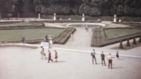 Paris - 1959: panoramic shot of visitors walking in Versailles Gardens Stock Footage 252662902