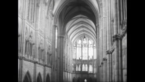 PARIS - 1961 - View of pointed arches and large stained glass windows inside the Stock-Footage 340664779