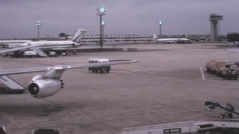 Paris - 1970: Mini bus with passengers drive through the strip of the airport Stock Footage 165660796
